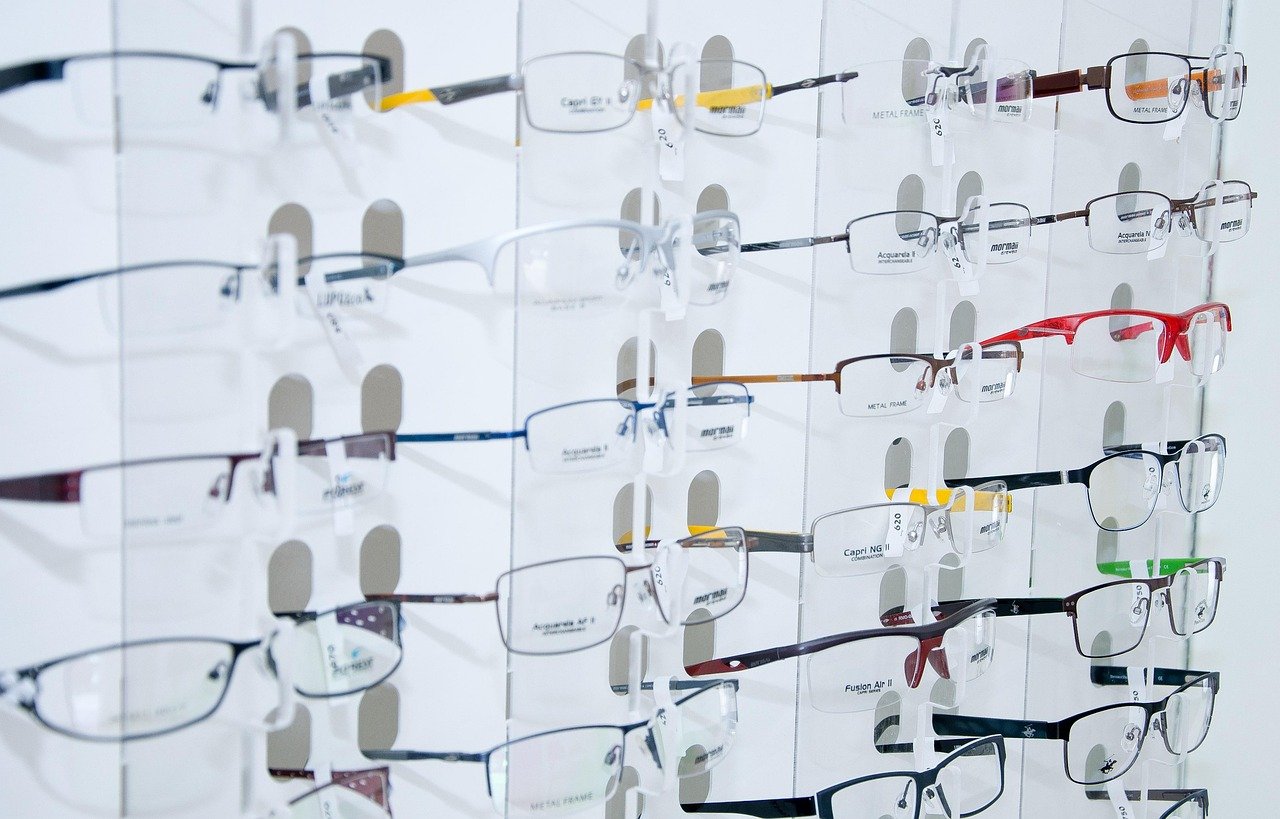 Rows of eyeglasses frames on display at an optical shop