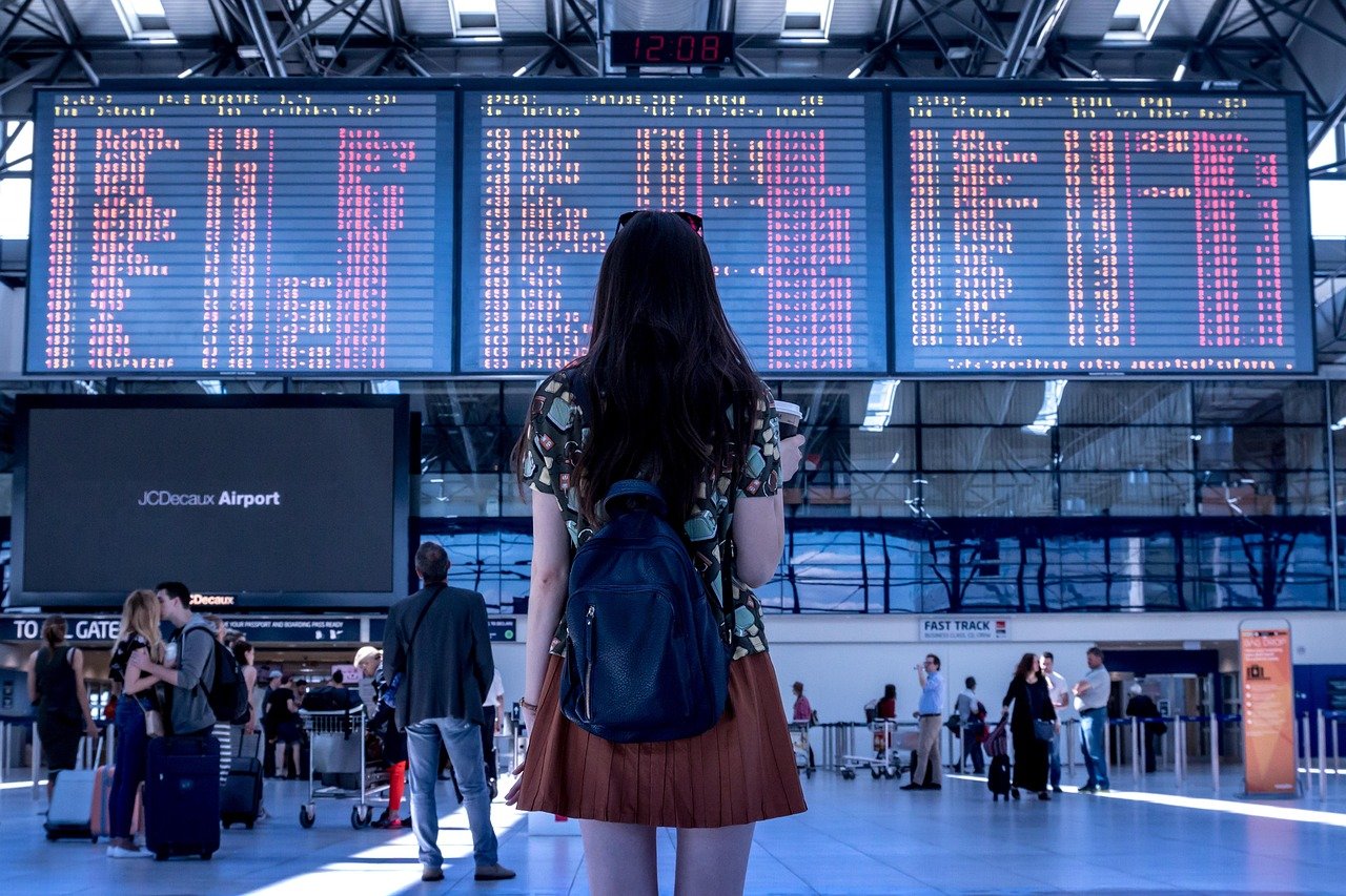 Traveler checking the flight information board after arriving at the airport in Korea