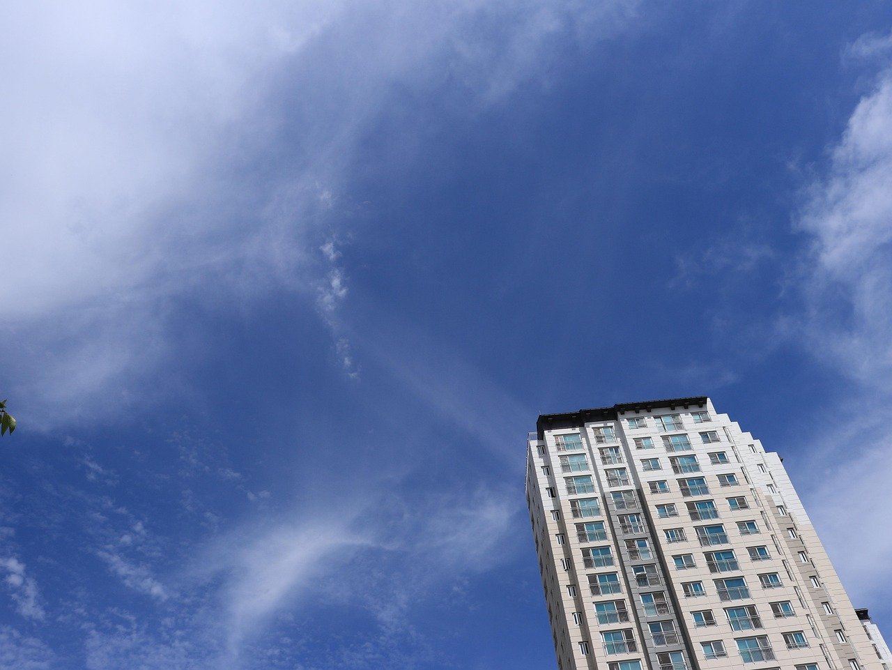 Korean high-rise apartment complex against a blue sky