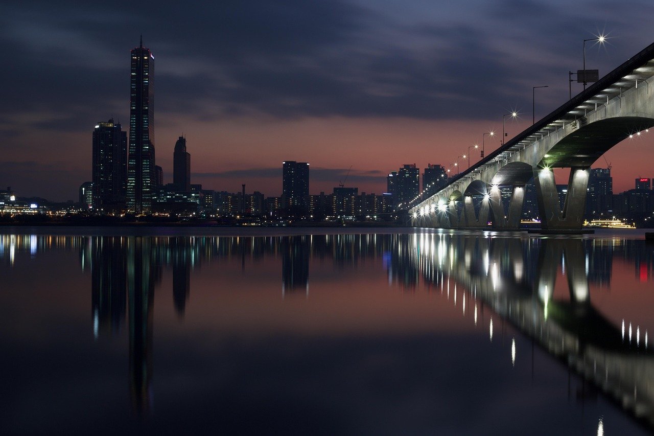 Han River bridge and Seoul skyline reflected on the water at night