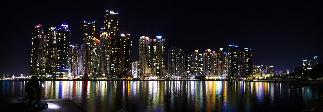 Marine City skyline of glass skyscrapers in Busan reflected in the water at night