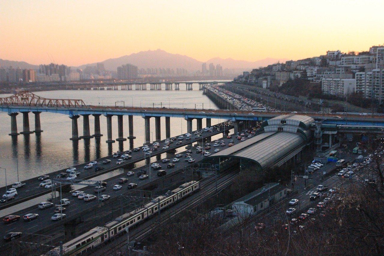 Seoul subway train crossing a bridge over the Han River at sunset