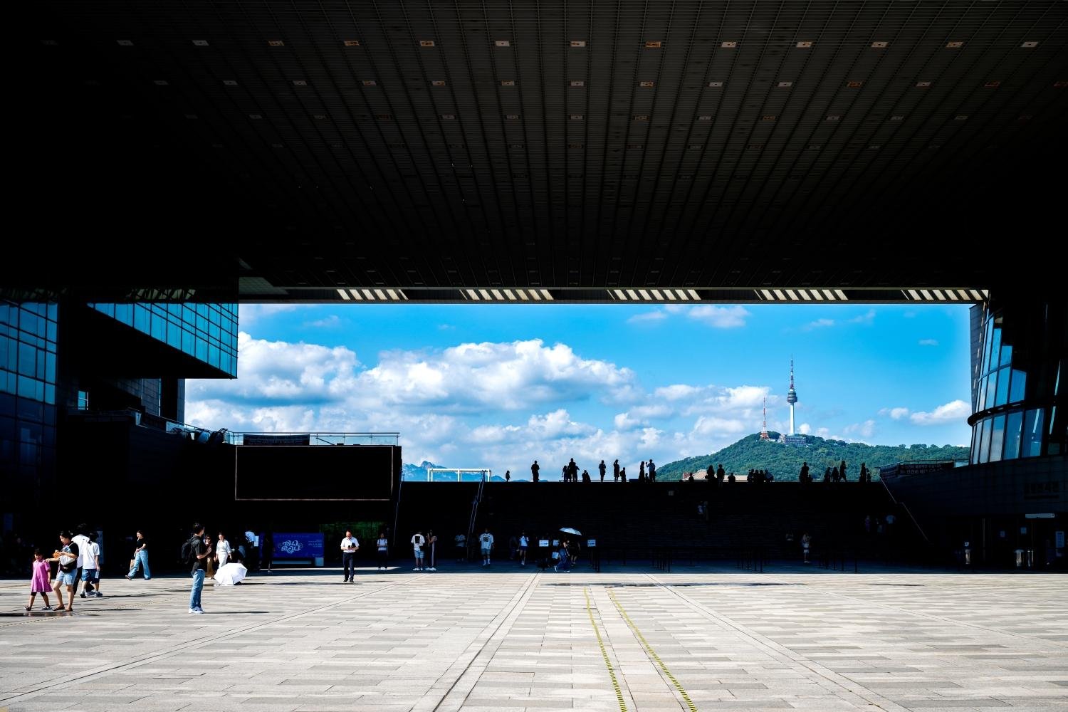 N Seoul Tower framed beneath the National Museum of Korea's main hall, seen from the plaza