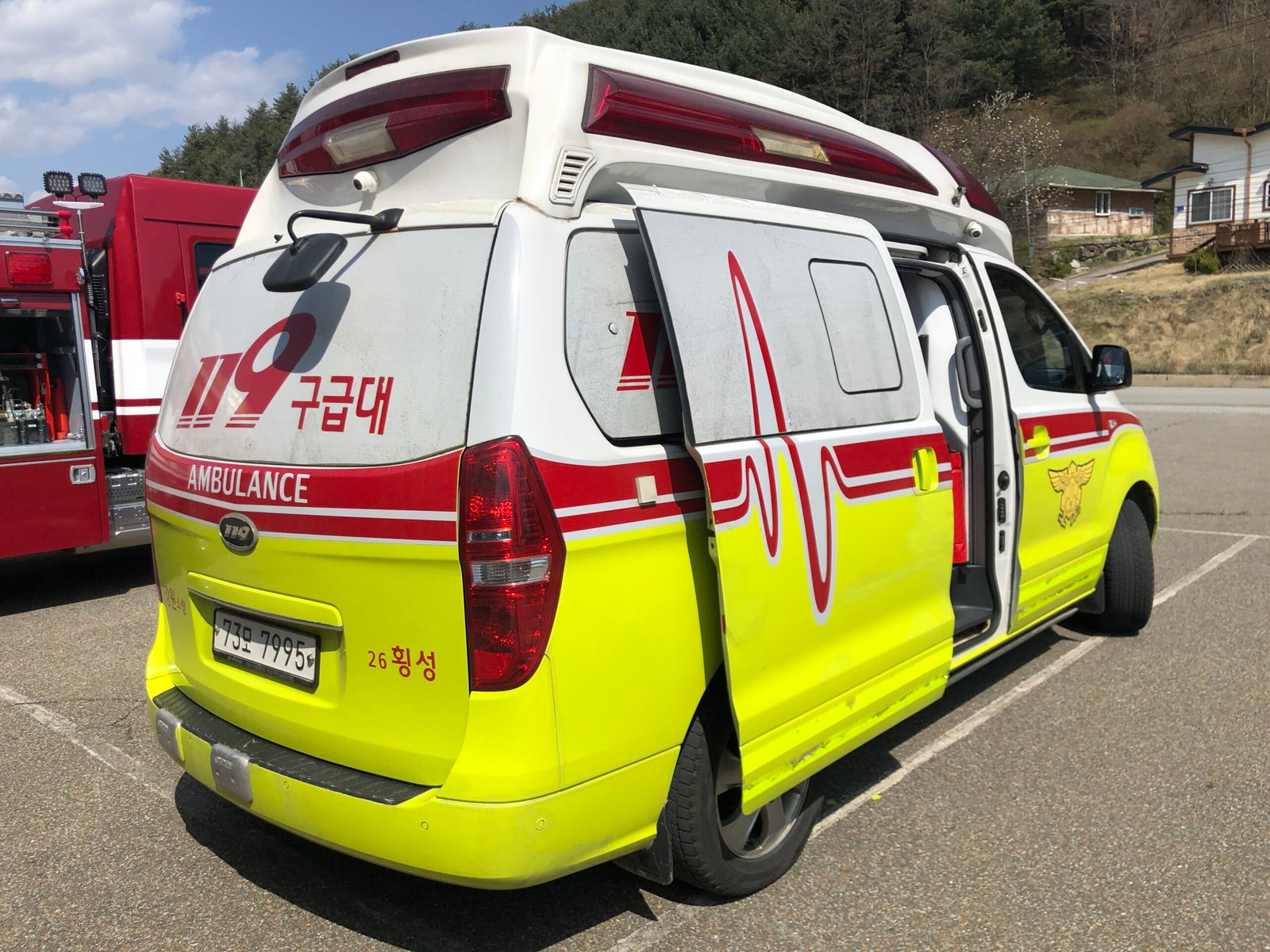Korean 119 ambulance with AMBULANCE and Korean text markings, seen from the rear side angle