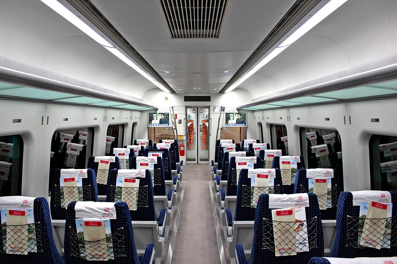 Inside the express train - reserved seats and room for cases.