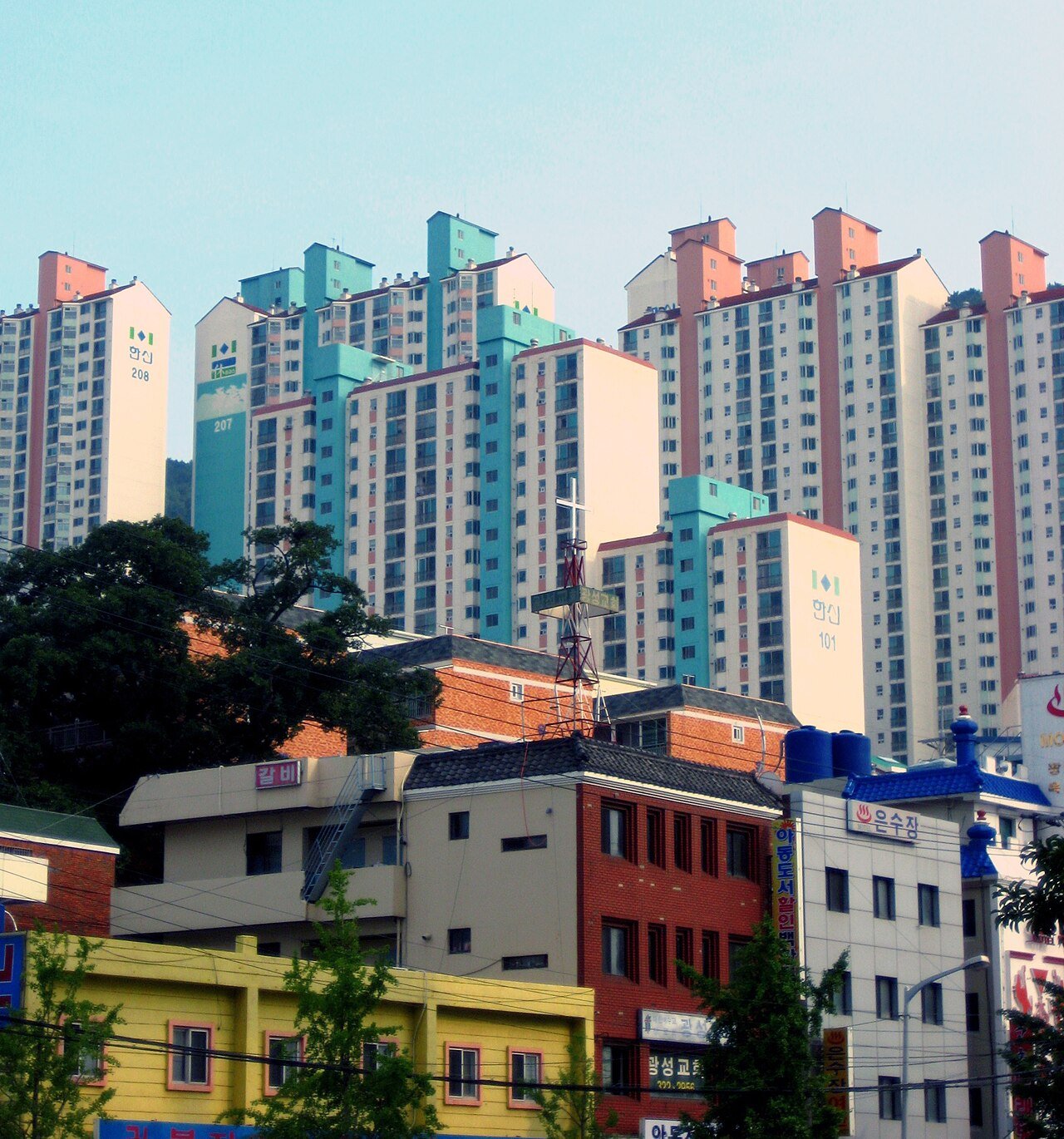 Apartment towers rising behind low-rise villa housing in Eomgung-dong, Busan