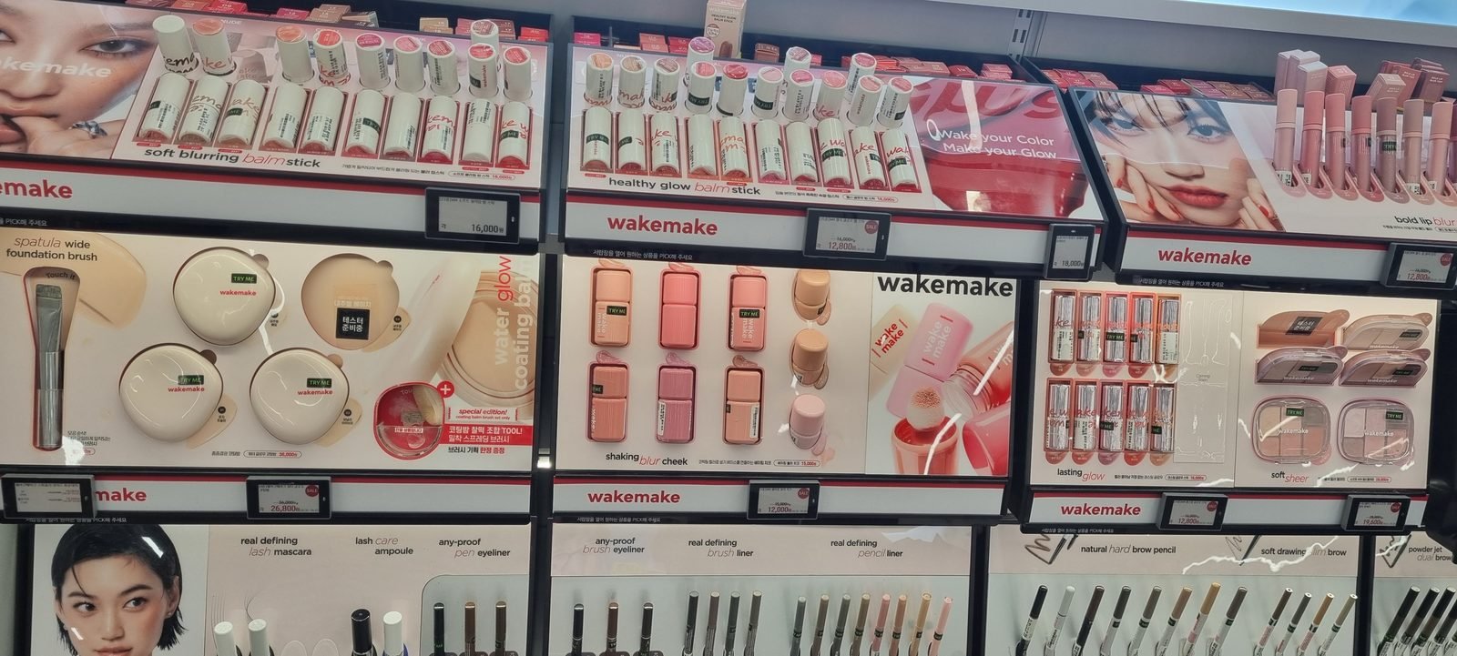 Cushion foundations and balms with TRY ME tester labels on a shelf at Olive Young