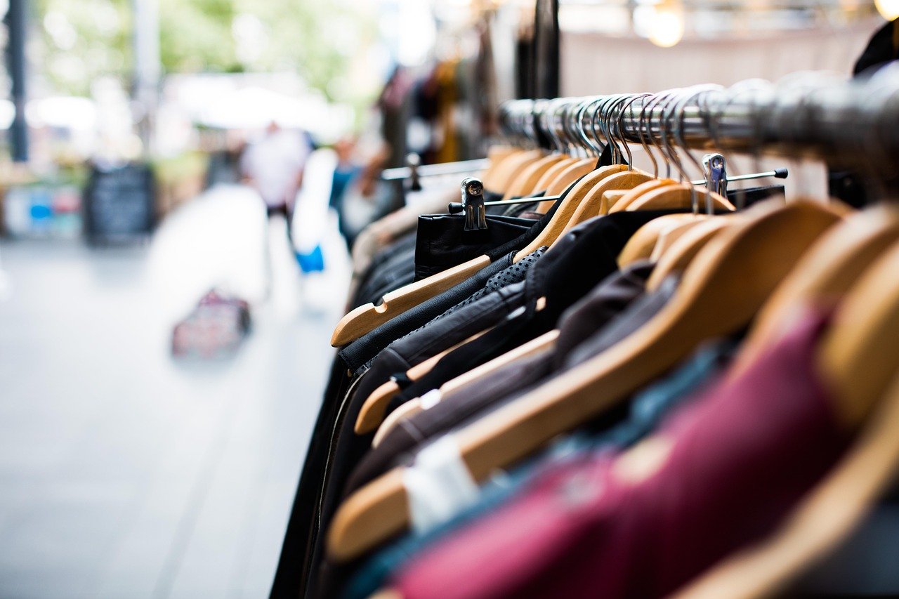 Clothes packed tightly on a rail in a small Korean boutique