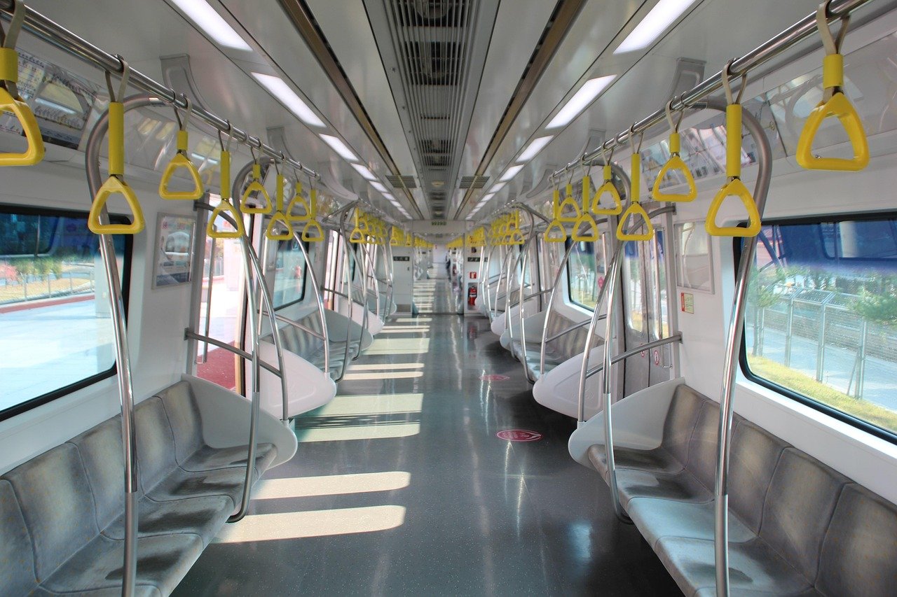 Interior of a Korean subway train car with yellow handle straps