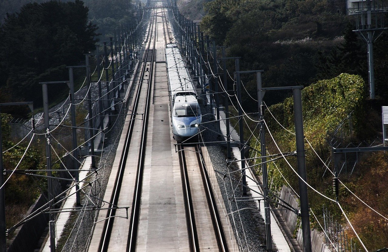 A KTX high-speed train running on a double-track high-speed line in Korea, seen from above
