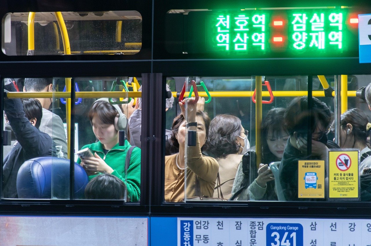 Passengers standing inside a crowded Seoul city bus number 341